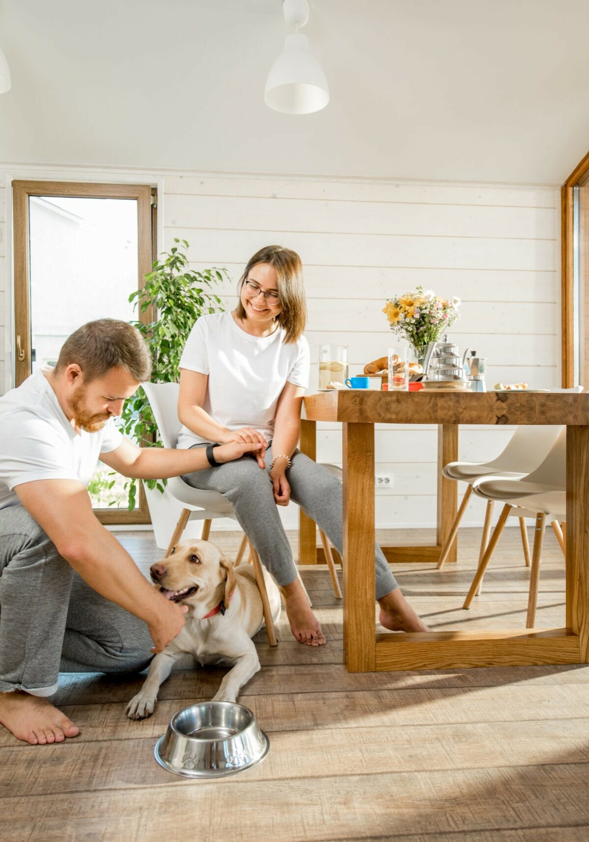 Young couple with dog at home | Melbourne Beach Flooring & Kitchens